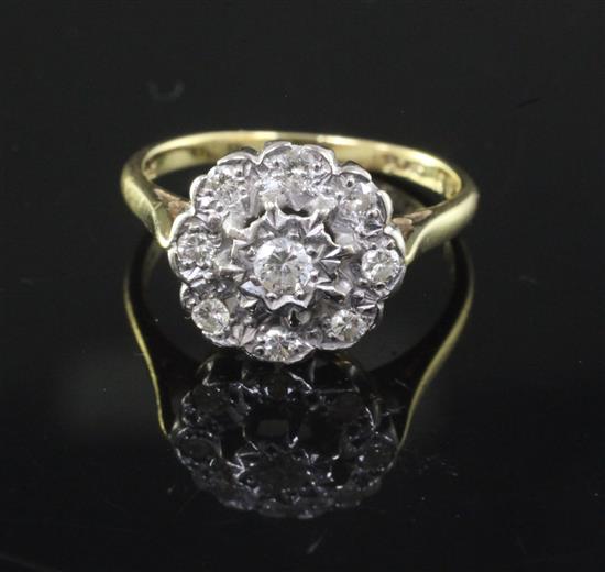 An 18ct gold, platinum and illusion set diamond nine-stone cluster ring, size O.